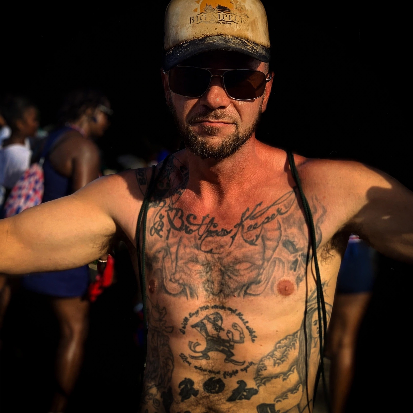 Props at the Placencia Carnival, mud on his hat, shades on